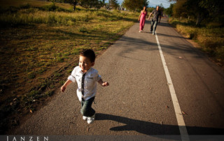 Child running away from parents in a playful family portrait