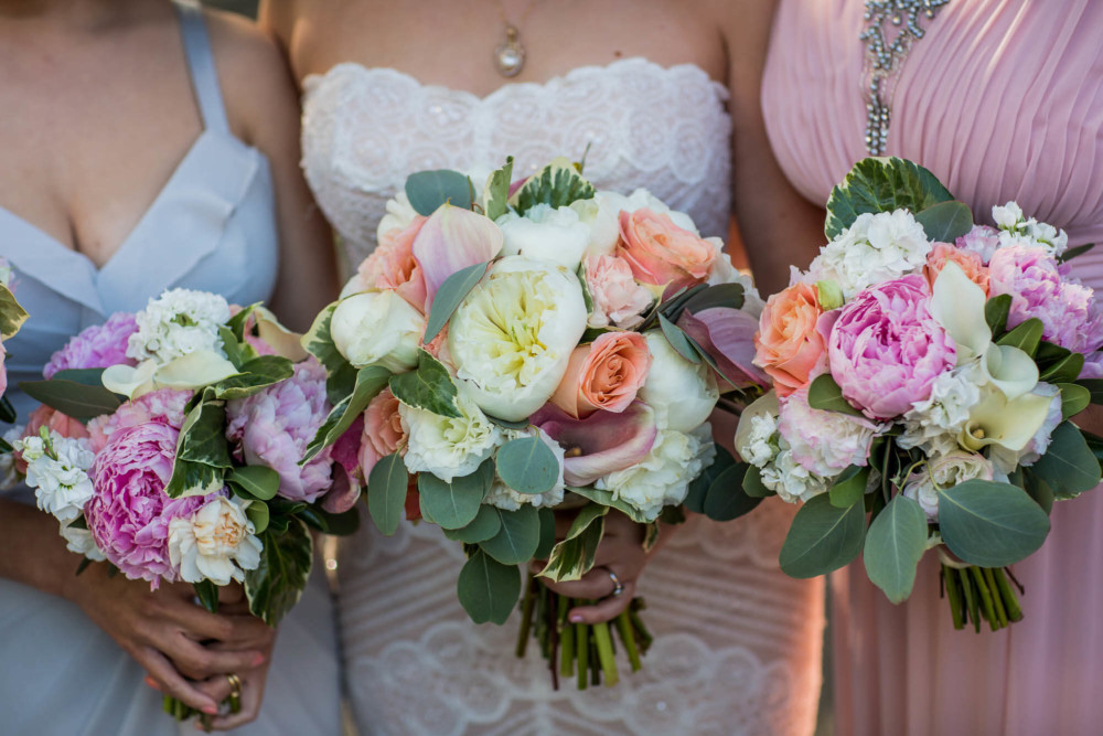Bride and bridesmaids bouquets full of peonies at a wedding at The Winchester Mystery House in San Jose, CA
