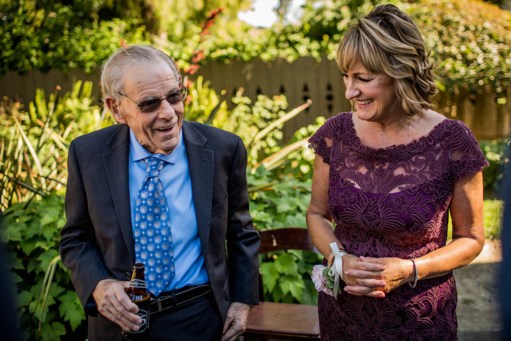 Mother and Grandpa share a laugh at a wedding at The Winchester Mystery House in San Jose, CA