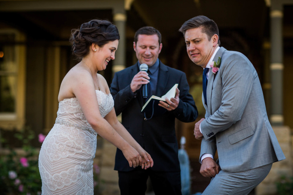 Awkward faces by the bride and groom during their wedding ceremony at the Winchester Mystery House in San Jose, CA