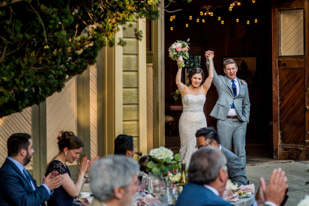 The bride and groom enter their wedding reception at The Winchester Mystery House in San Jose, CA