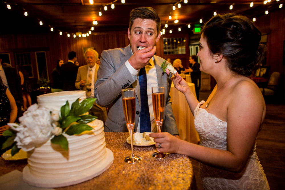 Groom feeds himself the cake instead of the bride during the cake cutting at a reception at the Winchester Mystery House in San Jose, CA