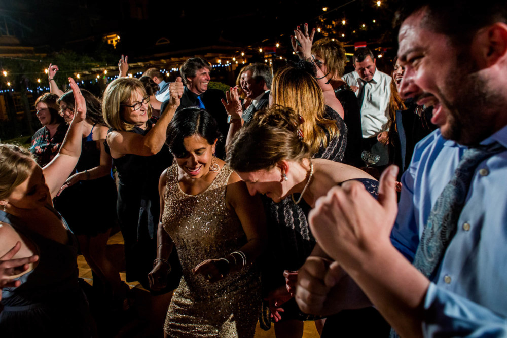 A group of wedding guests dancing at a reception at the Winchester Mystery House in San Jose, CA