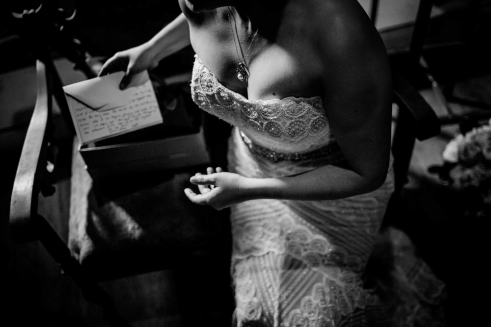 Dramatic image of a bride's dress, necklace and letter from the groom at The Winchester Mystery House in San Jose, CA