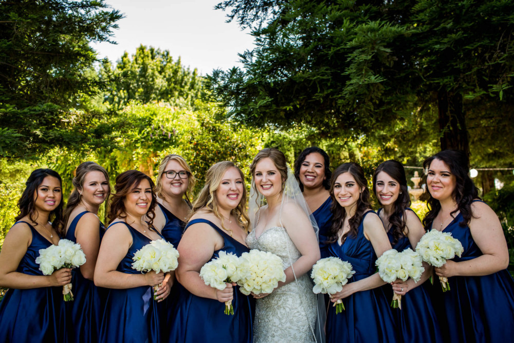 Portrait of a bride and her bridesmaids dressed in blue at Wolf Lakes Park