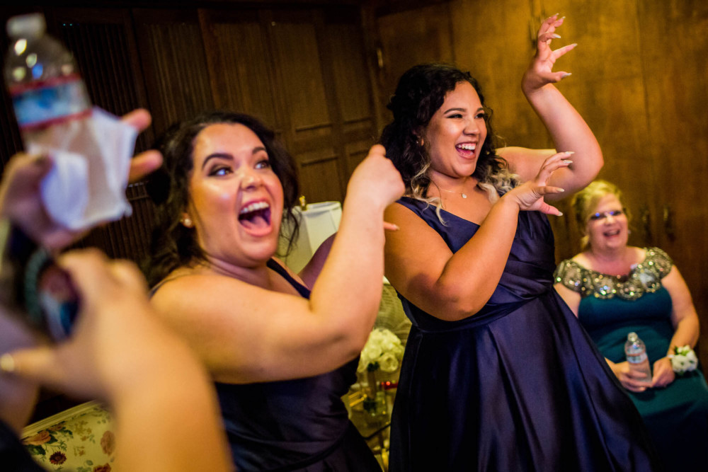 Bridesmaids dancing while waiting for the wedding to start