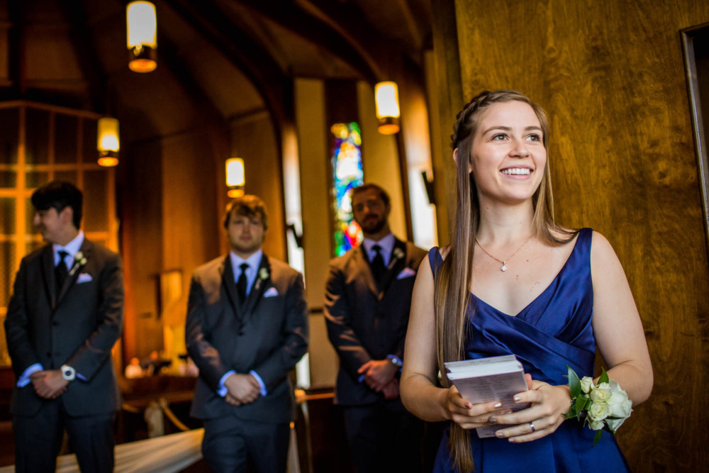 Girl handing out programs before a wedding at the church