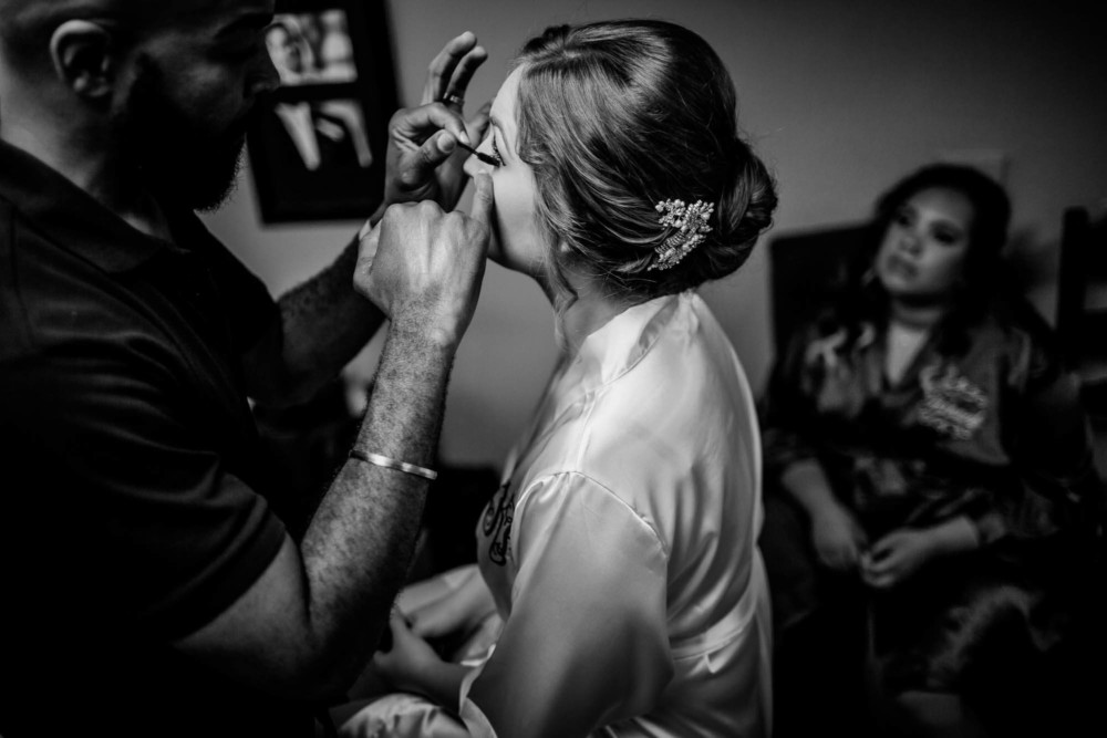 Bride having eye makeup applied before her wedding at Wolf Lakes Park