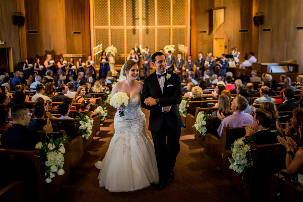 Bride and groom exit down the aisle after their wedding at Pilgrim Armenian Church