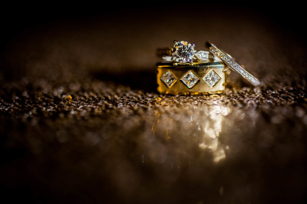 Bride and Groom's wedding rings on shiny gold table