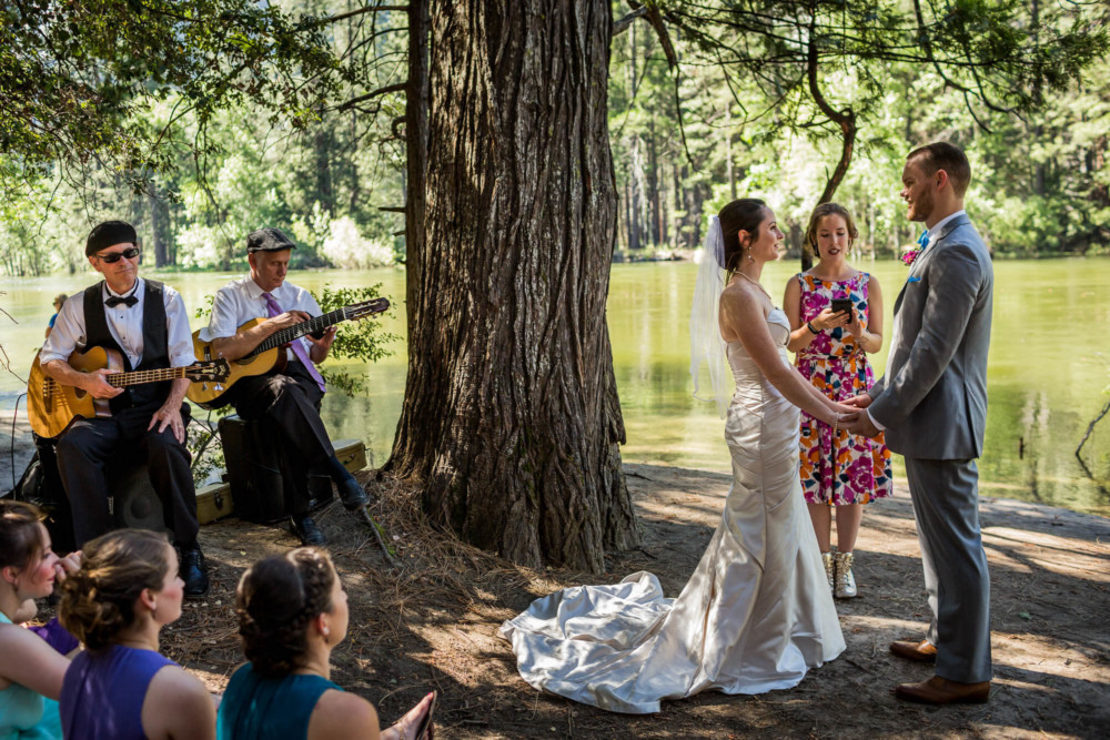 Bride and groom getting married on Cathedral Beach next to the Merced River in Yosemite Valley