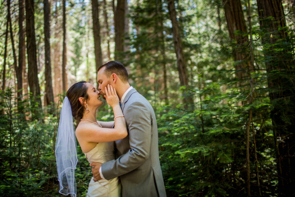 Portrait of a bride and groom in the forest before their wedding in Yosemite National Park