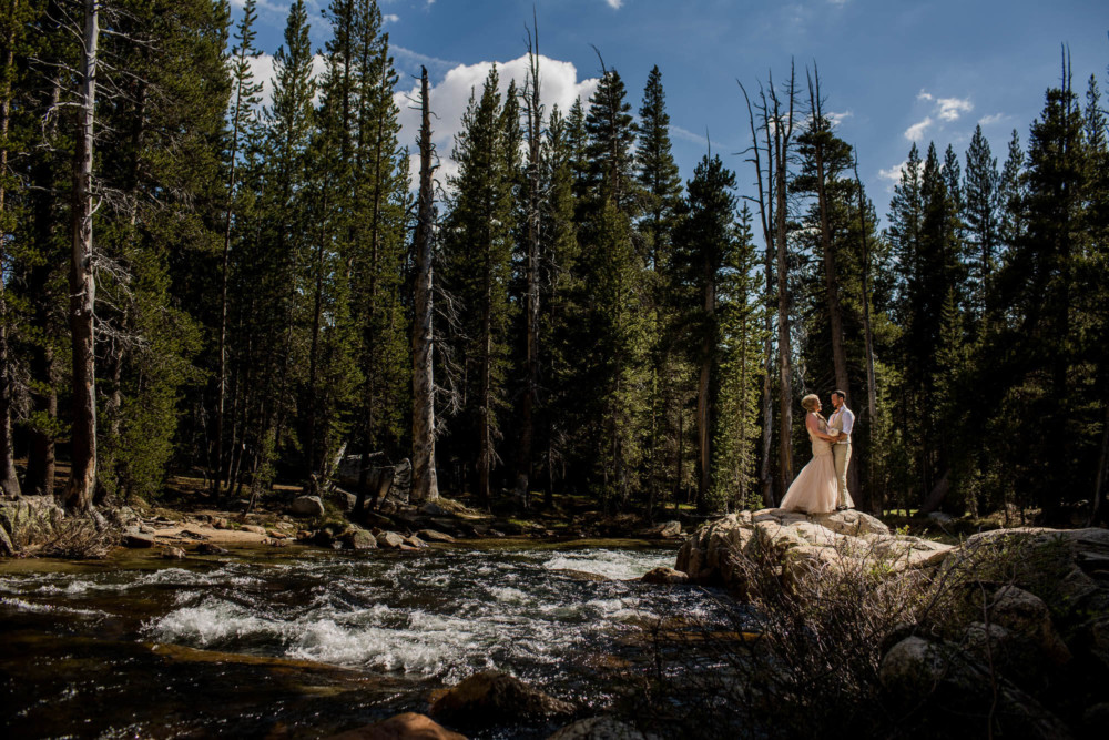 Portrait of a Bride and Groom by the Tuolumne River after their elopement in Tuolumne Meadows in Yosemite National Park