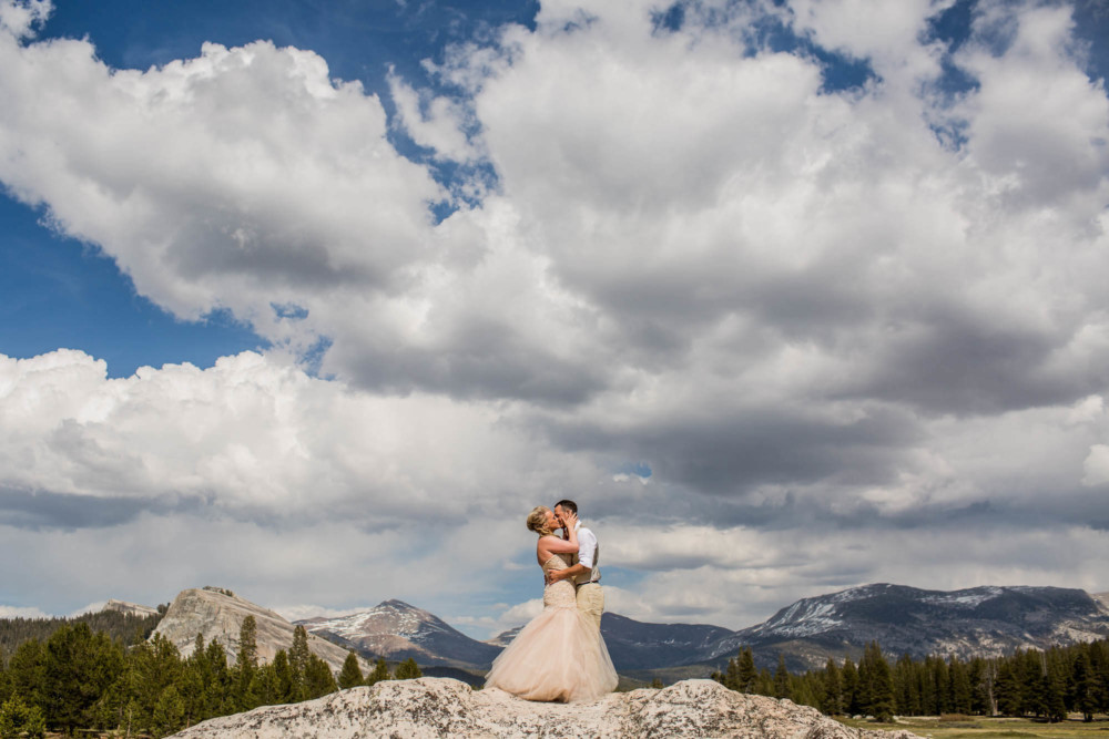 Portrait of a Bride and Groom under a dramatic sky after their elopement in Tuolumne Meadows in Yosemite National Park