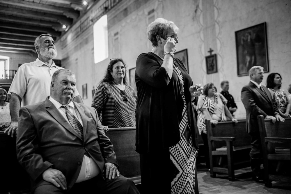 Mother of the groom wipes away a tear during the wedding ceremony