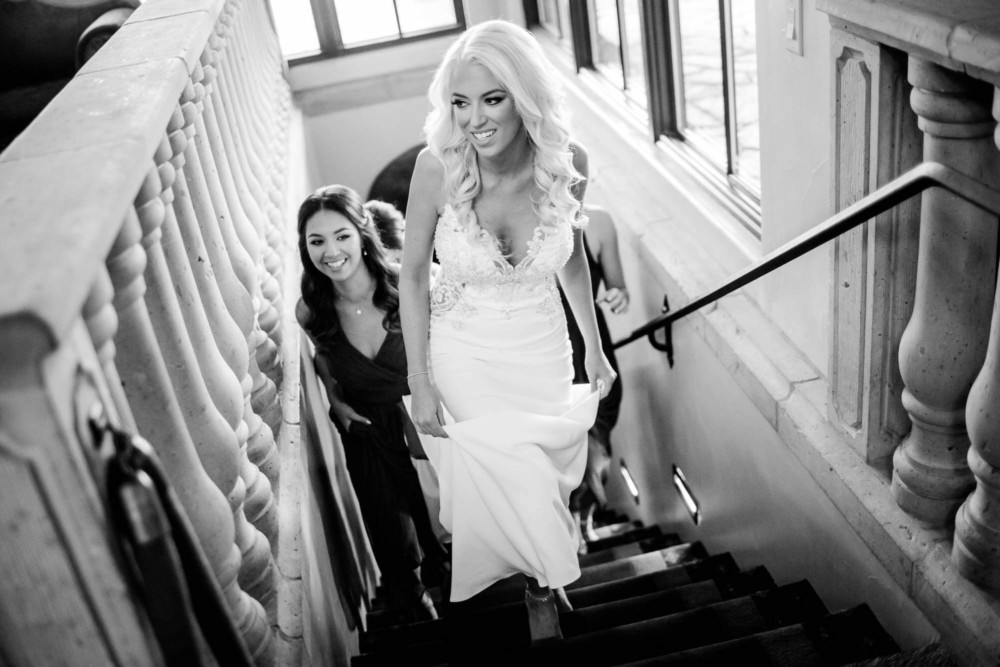The bride arrives for her wedding up the stairs at Copper River Country Club