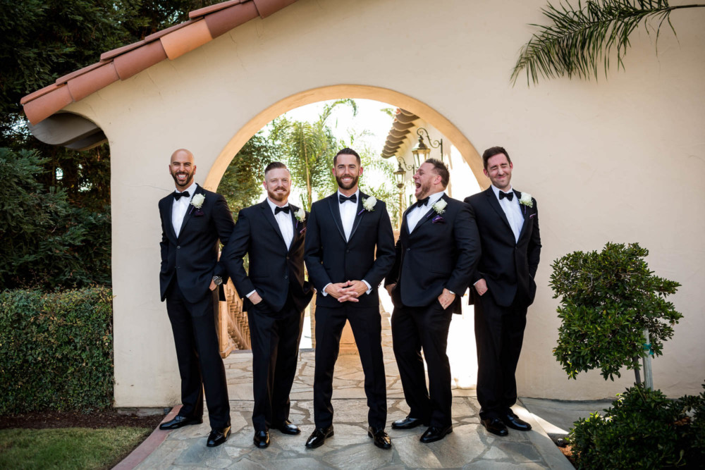 Groomsmen's portrait under the arch at Copper River Country Club