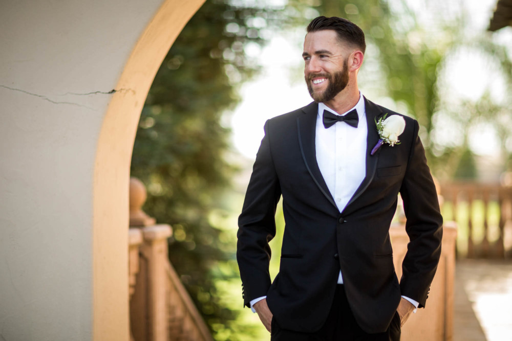 Groom's portrait under the arch at Copper River Country Club