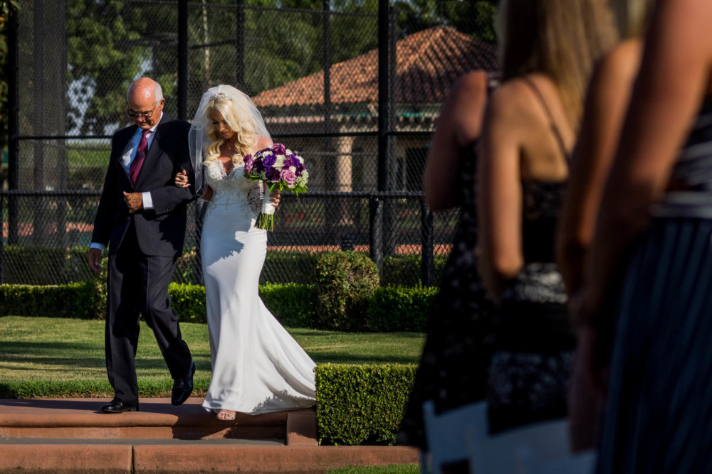 The bride and her father come down the aisle at Copper River Country Club