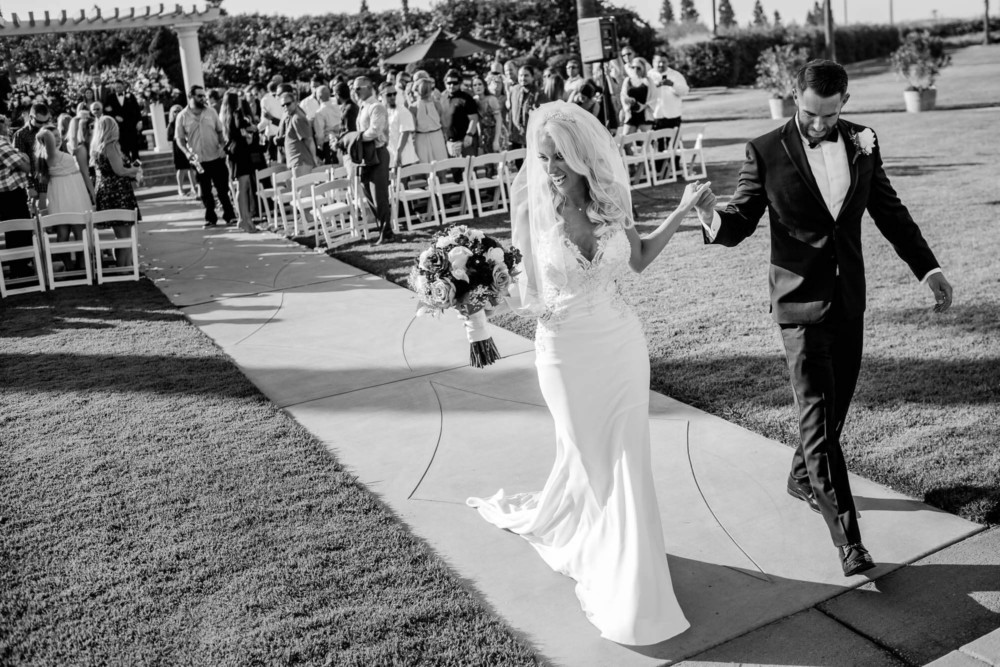 Bride and groom walk back down the aisle after their wedding at Copper River Country Club