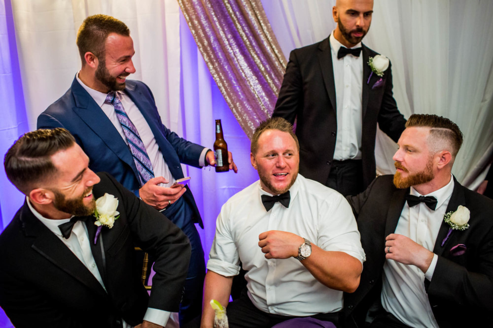 Wedding guests react and laugh during a reception at Copper River Country Club
