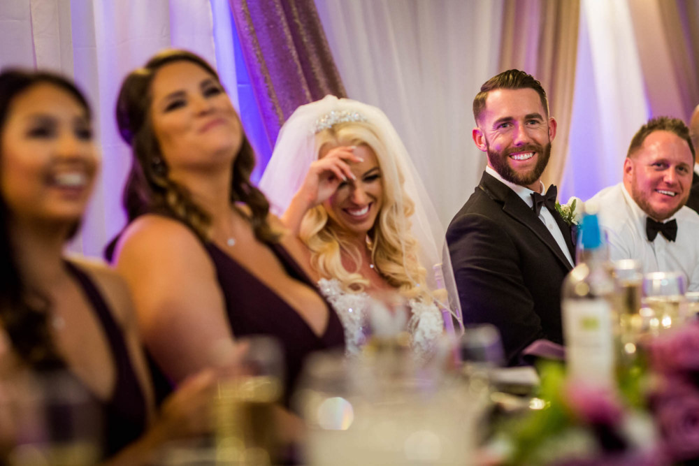 Bride and groom react to the father of bride's speech at Copper river country club