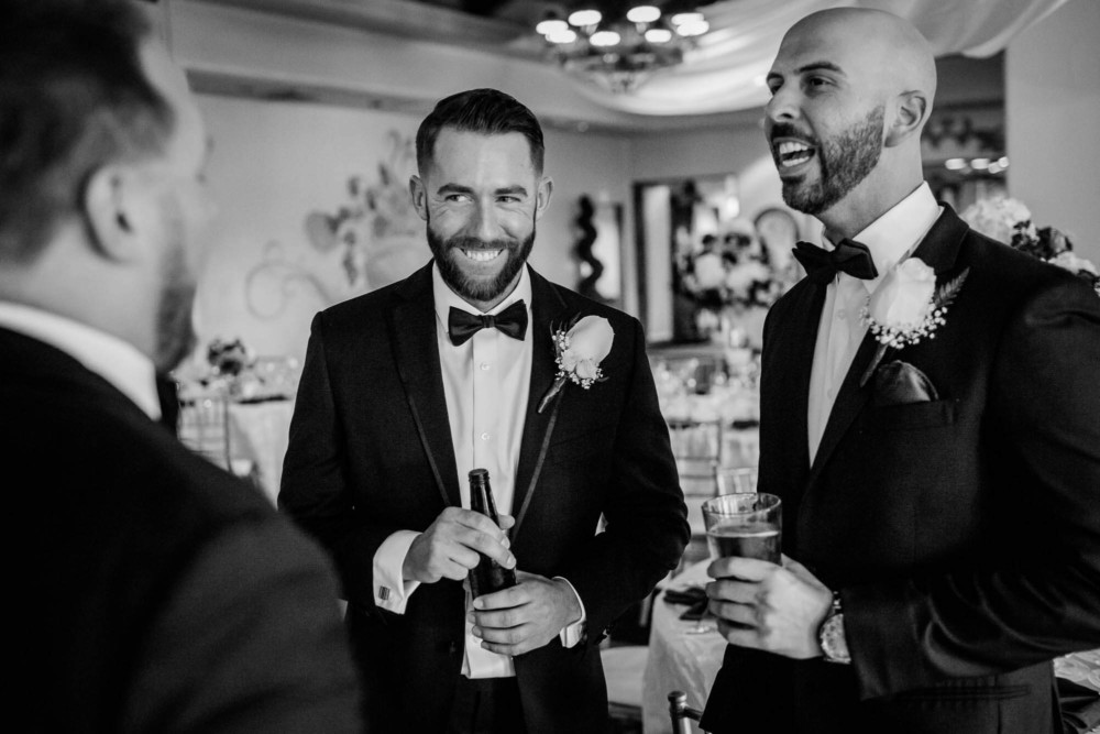 A groom and groomsmen share a funny moment before the wedding at Copper river Country Club