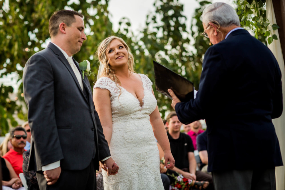 Bride steals a glance at the groom during their wedding ceremony