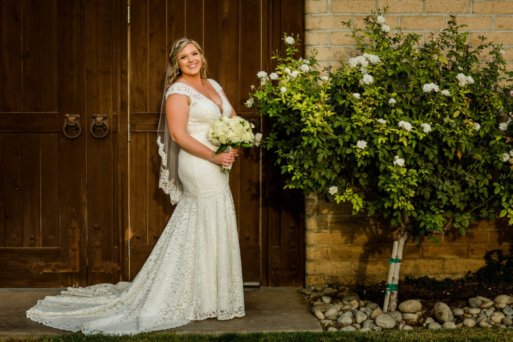 Portrait of the bride in front of a winery door