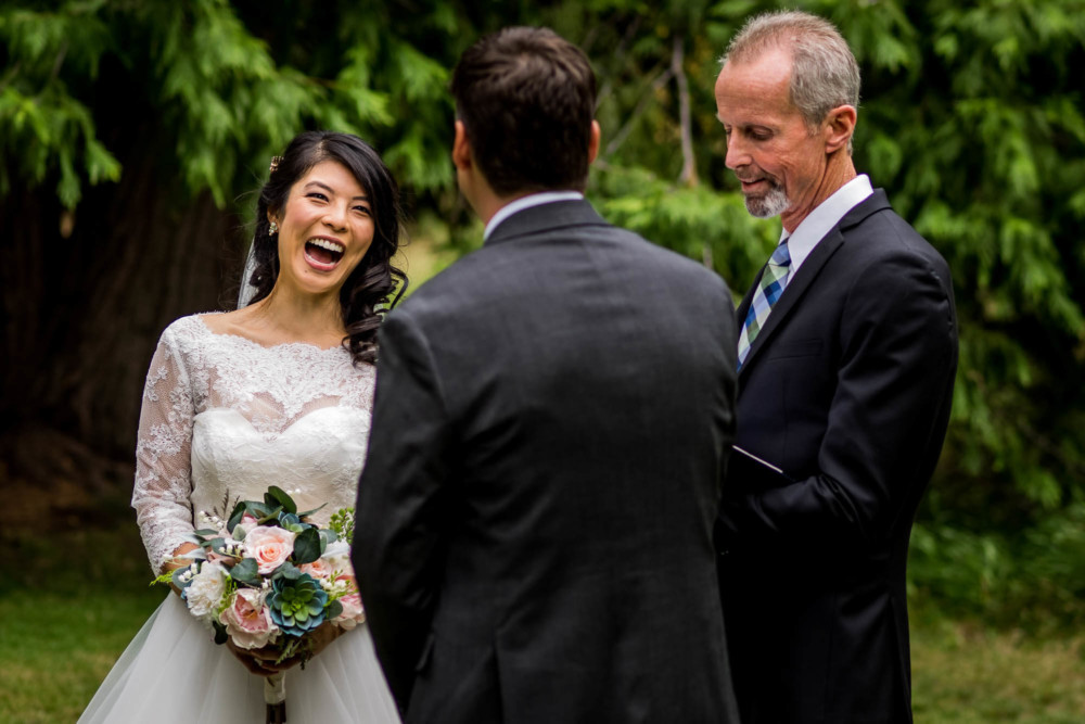 Bride laughs during the wedding ceremony
