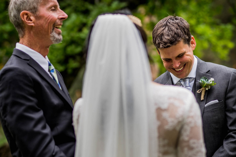 Groom laugh during their wedding vows