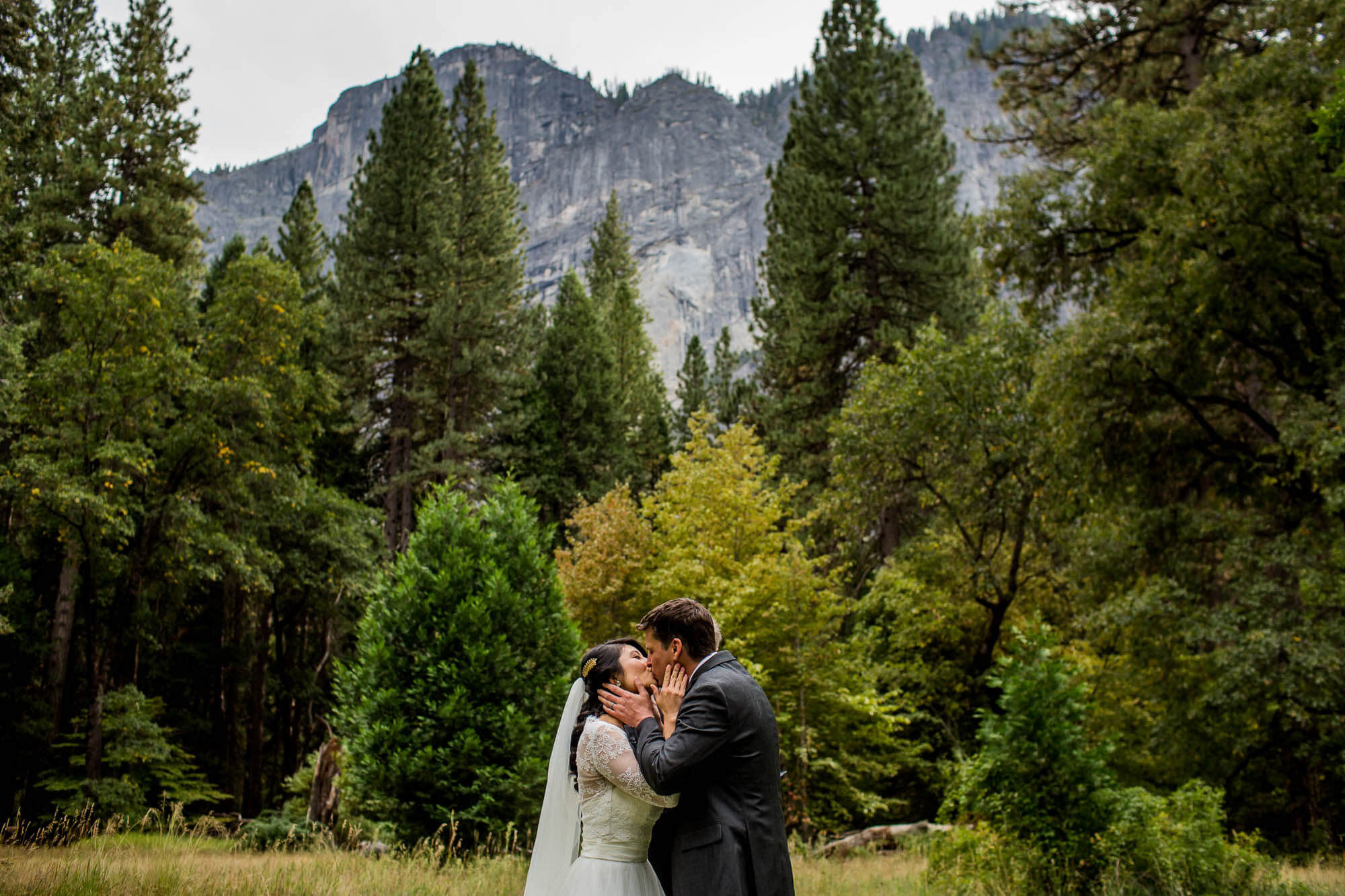 Bride and groom's first kiss under Glacier Point