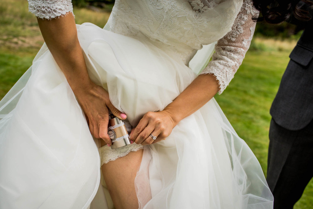 Bride shows off her garter and flask
