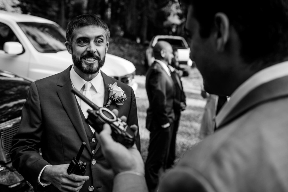Groom and friend play with walkie talkie's before the ceremony