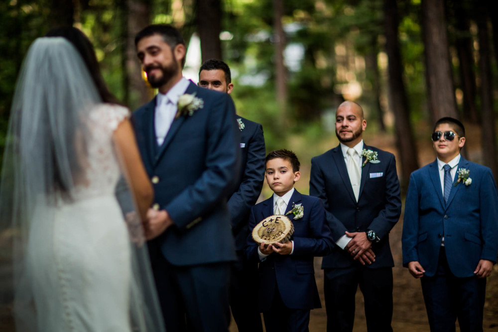 Ring bearer looks on during the wedding ceremony