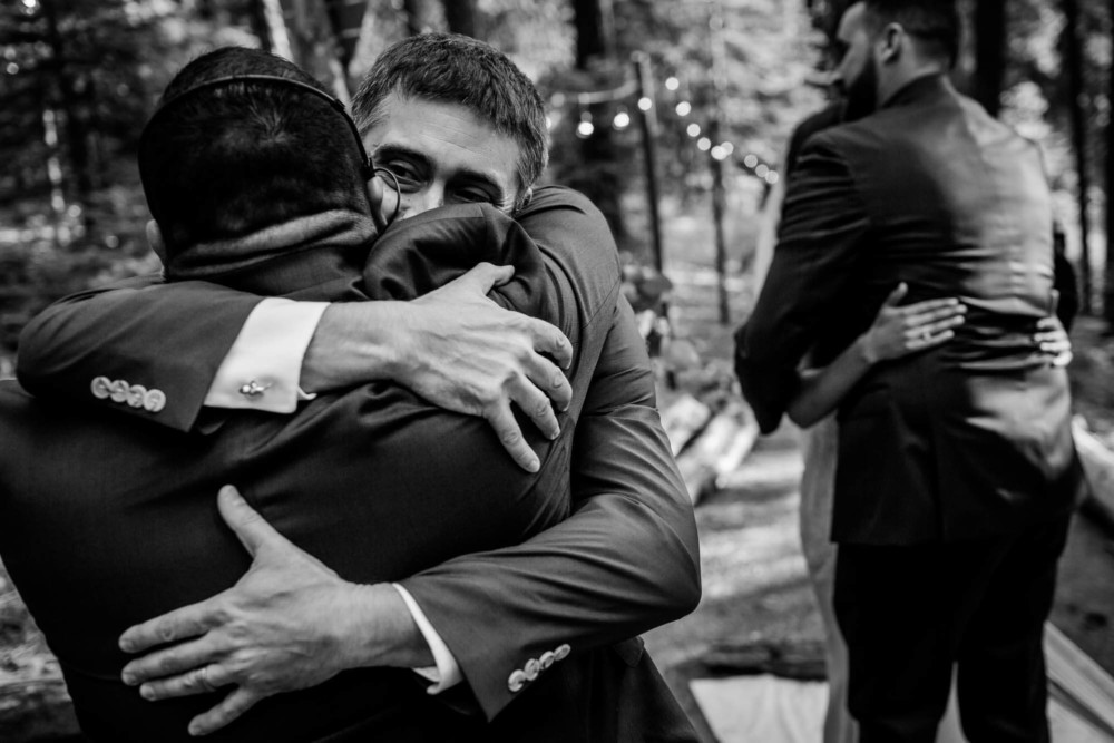 Hugs and congratulations between the bride, groom and their friends after the wedding ceremony
