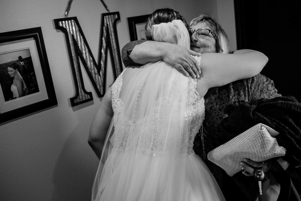 Bride hugs her mom before the wedding