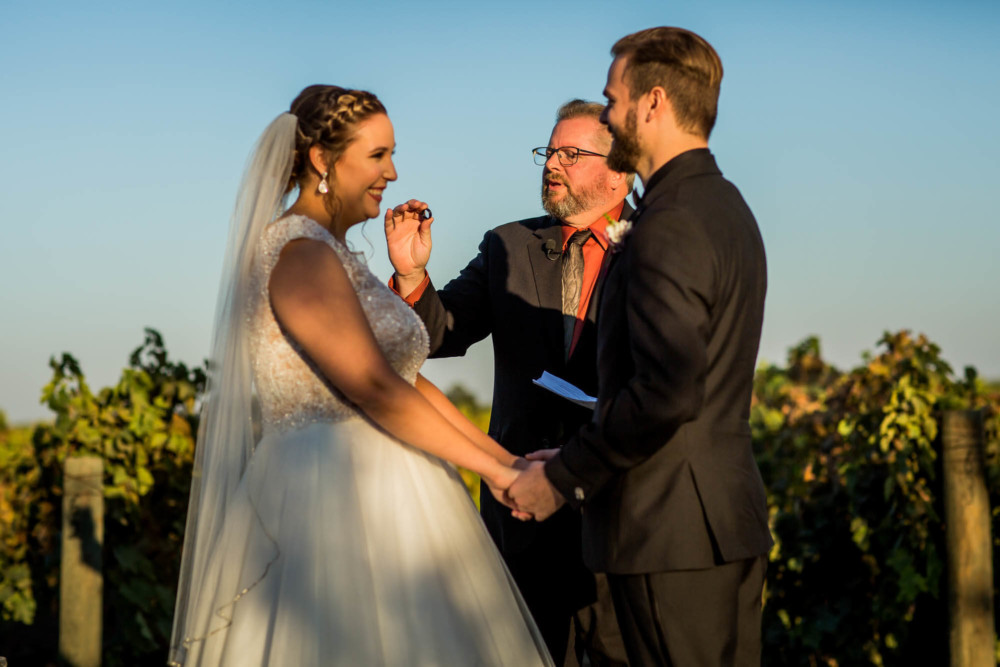 Officiant holds up a ring during the wedding ceremony