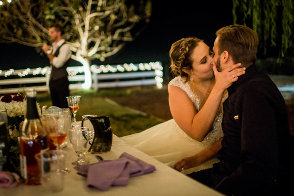 Bride and groom kiss during the wedding reception