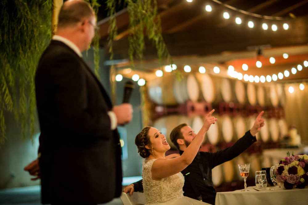 Bride and groom gesturing during toasts