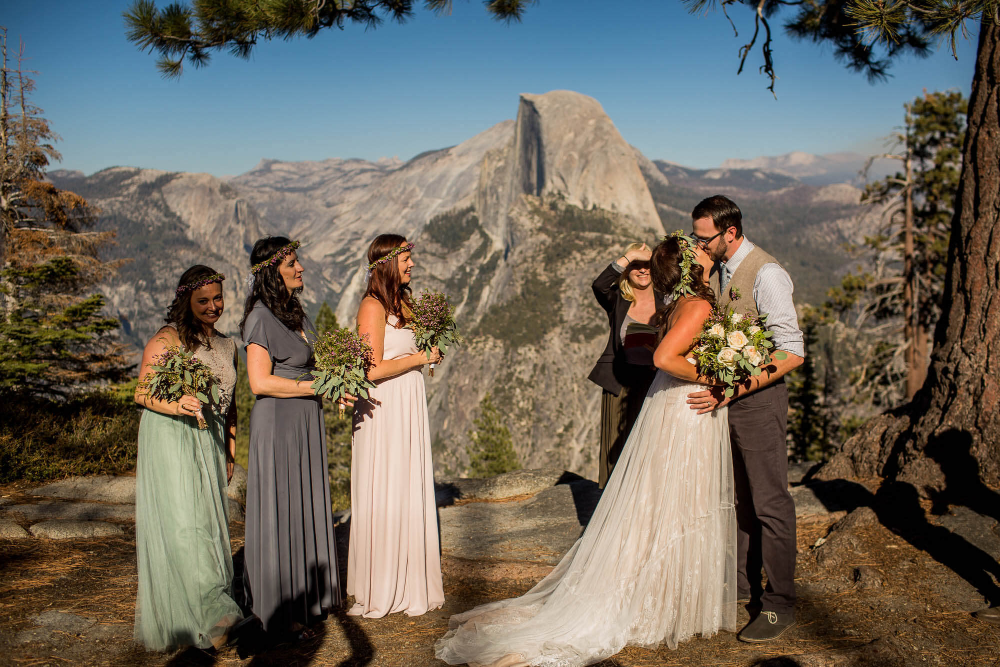First kiss in front of Half Dome during a Glacier Point wedding