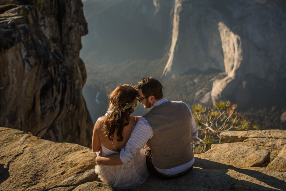Bride and groom share a moment looking across Yosemite Valley at El Capitan from Taft Point