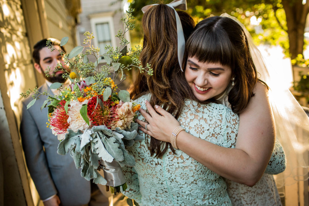 Bride hugs her bridesmaid after the ceremony