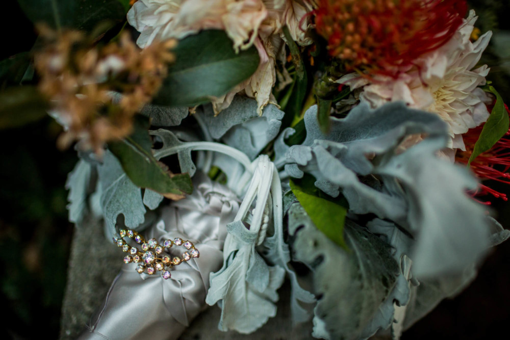 Detail of a broach on the bride's bouquet
