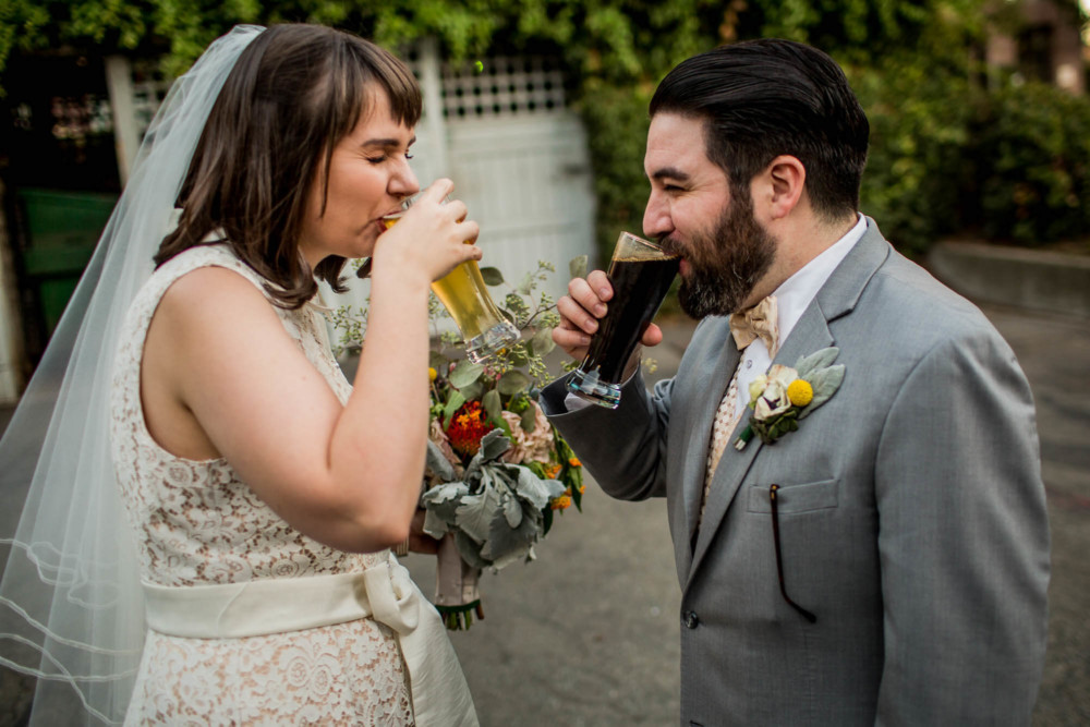 Bride and groom taste their beers before the wedding reception