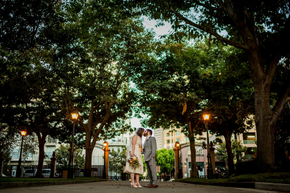Portrait of a bride and groom kissing at Oaklands Preservation Park