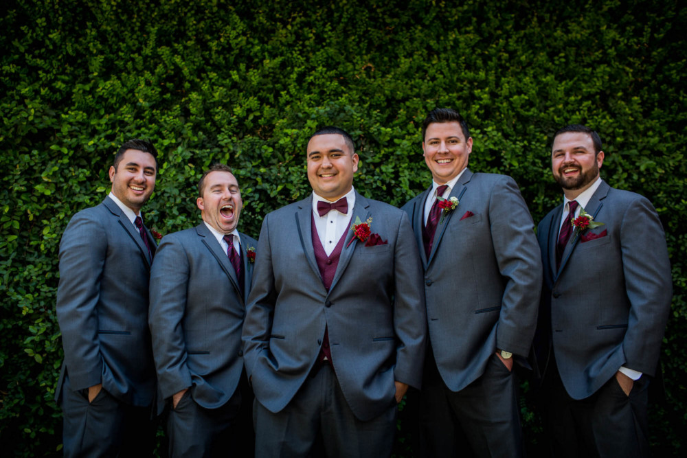 Groomsmen portrait in front of ivy covered wall
