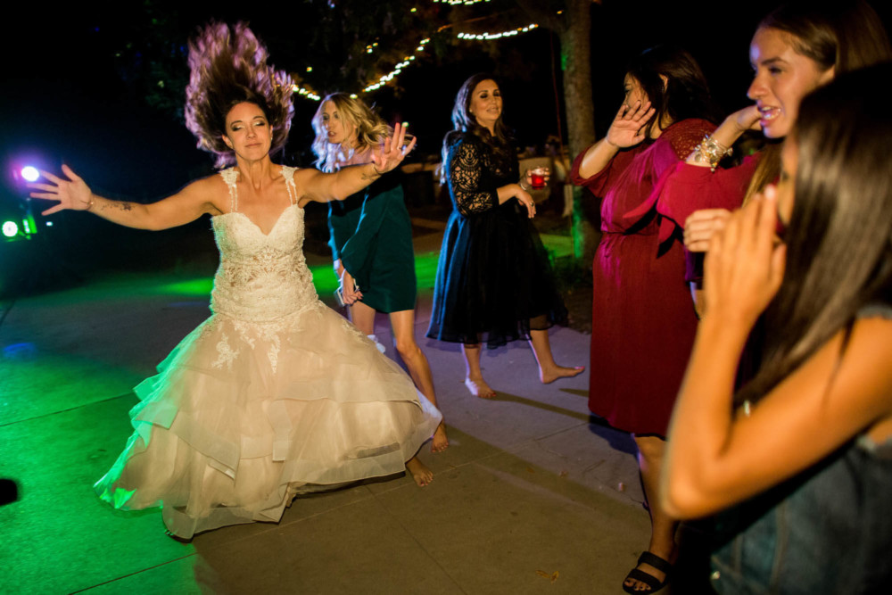 Bride has crazy hair while dancing during the wedding reception
