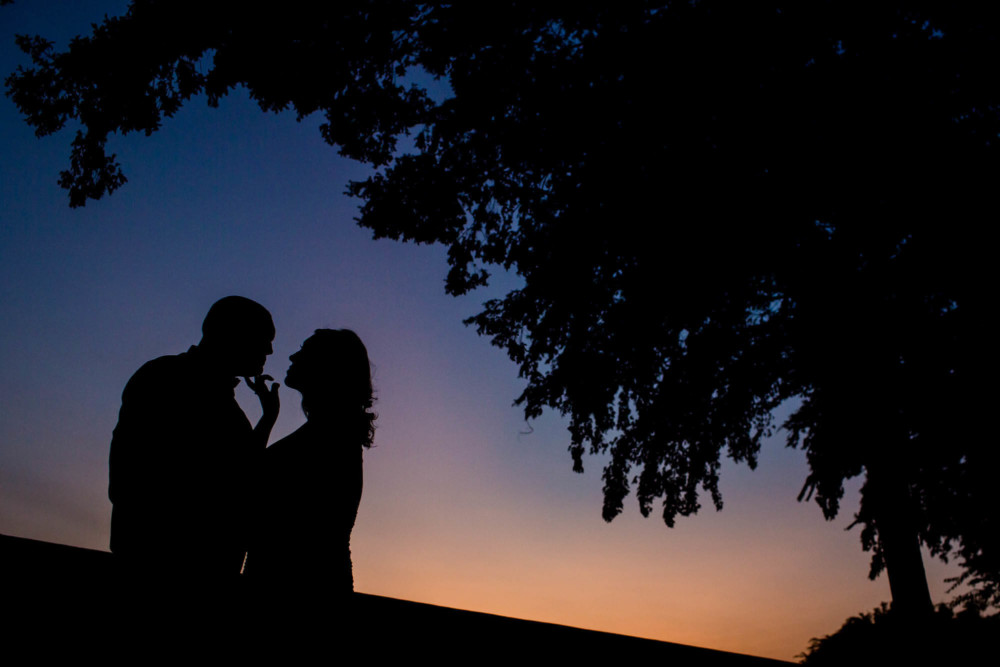 Silhouette of bride and groom at dusk