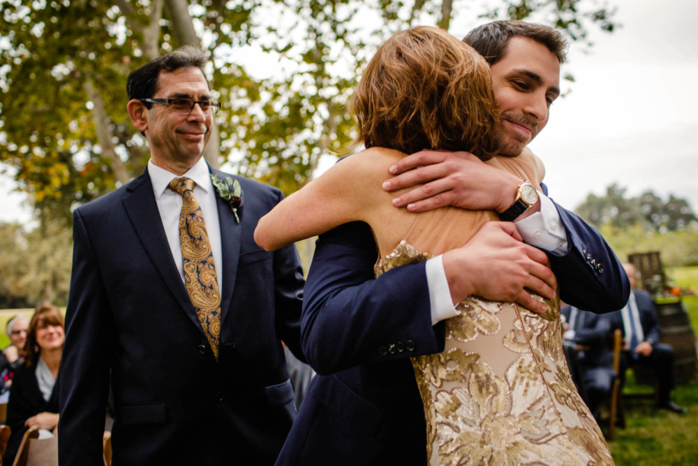 Groom hugs his mother prior to the wedding ceremony